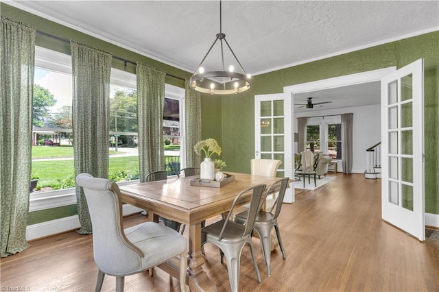 1501 Wiltshire St, High Point, NC 27265 - dining room featuring french doors, wood finished floors, a chandelier, plenty of natural light, and a textured wall