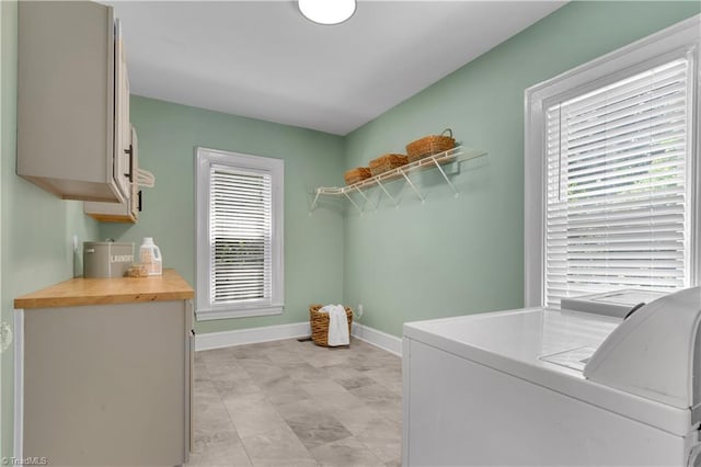 1501 Wiltshire St, High Point, NC 27265 - washroom featuring cabinet space, baseboards, separate washer and dryer, and plenty of natural light