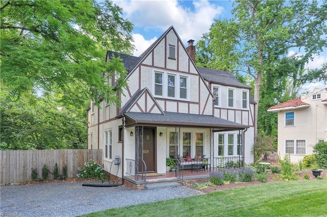 1501 Wiltshire St, High Point, NC 27265 - english style home with stucco siding, a chimney, covered porch, and a shingled roof