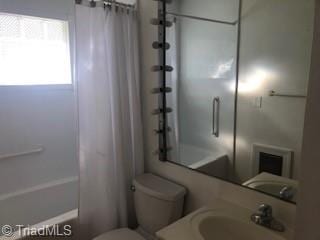 full bathroom featuring vanity, shower / bath combination with curtain, and toilet