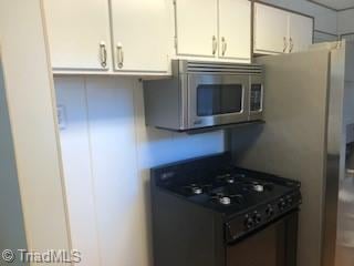 kitchen with white cabinets and gas stove