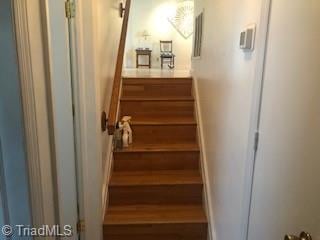 staircase featuring hardwood / wood-style flooring