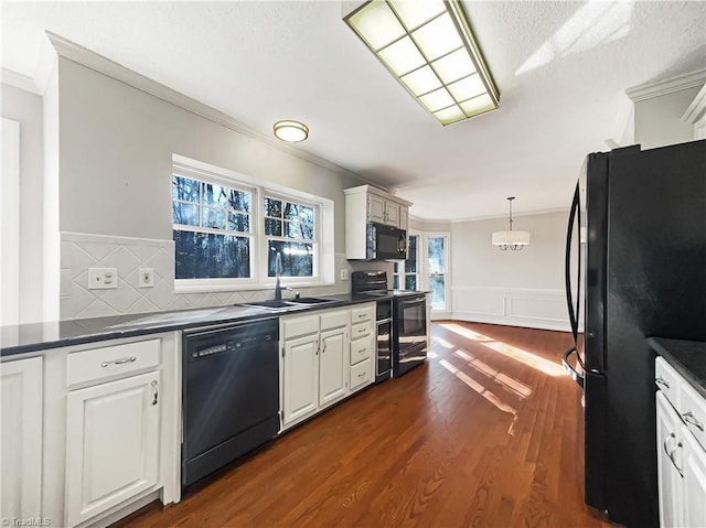 kitchen with black appliances, ornamental molding, dark hardwood / wood-style flooring, sink, and white cabinetry