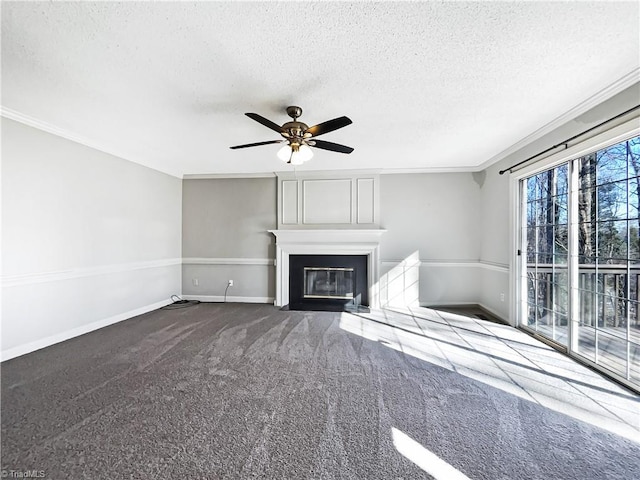 unfurnished living room featuring crown molding, ceiling fan, a fireplace, carpet flooring, and a textured ceiling