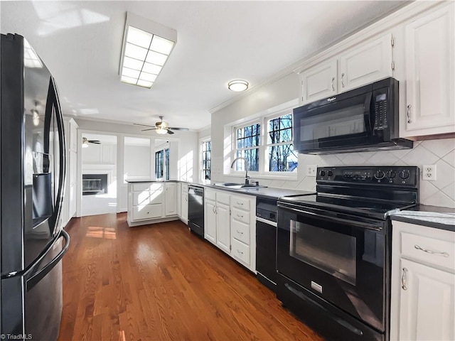 kitchen with sink, white cabinets, ceiling fan, dark hardwood / wood-style flooring, and black appliances