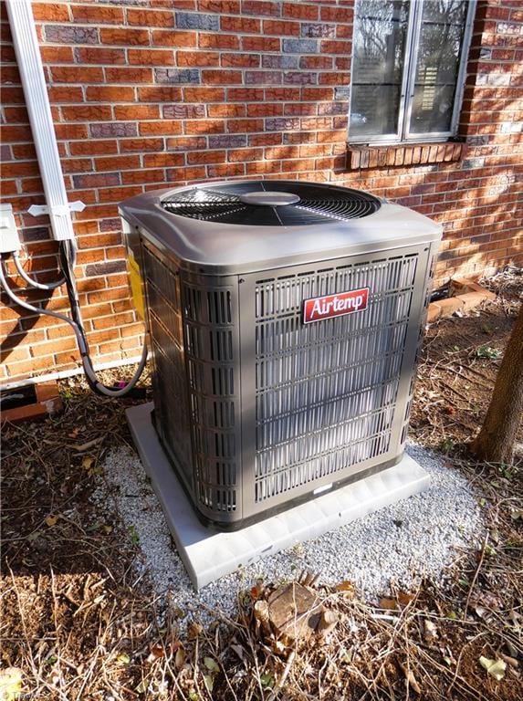 exterior details with brick siding and central air condition unit