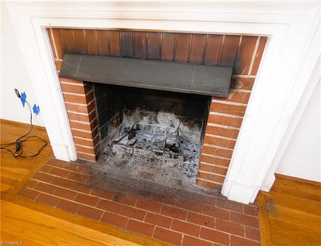 details with a brick fireplace and baseboards