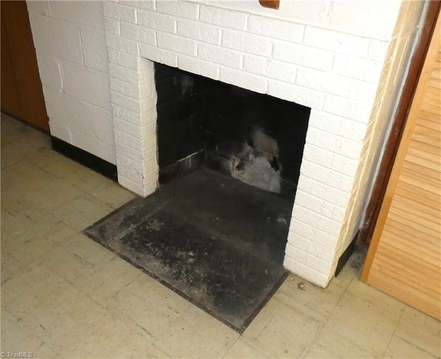 details featuring a brick fireplace and tile patterned floors