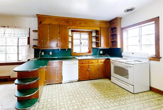 kitchen with white appliances, brown cabinetry, light floors, open shelves, and a sink