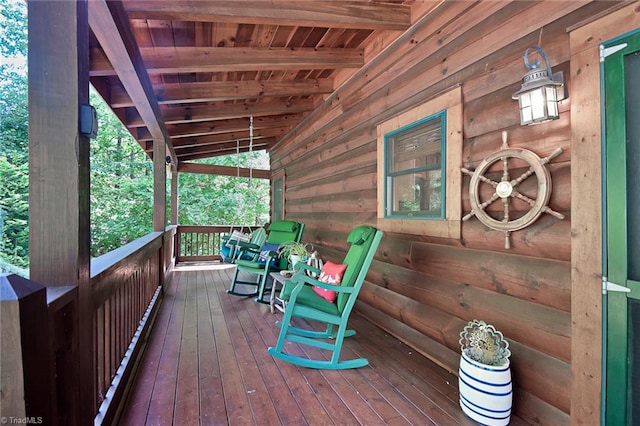 wooden terrace featuring covered porch