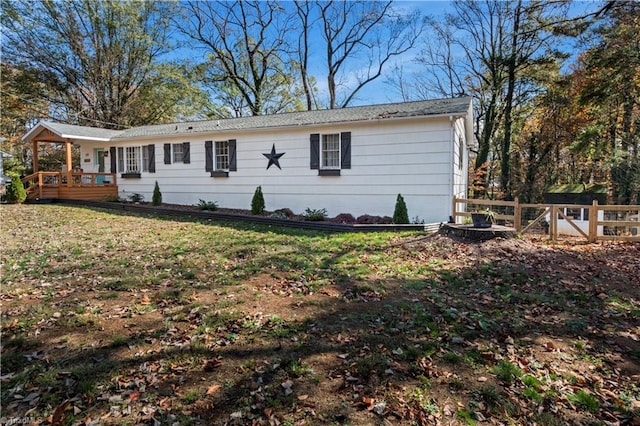 exterior space featuring a front yard and a deck