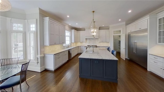 kitchen featuring crown molding, white cabinets, dark wood-style flooring, a sink, and stainless steel appliances