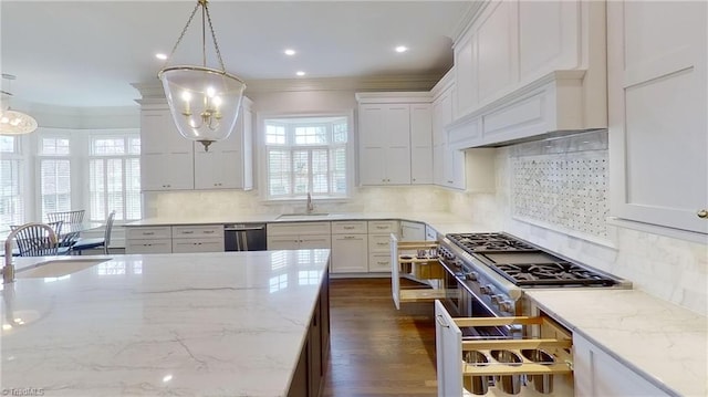 kitchen with dishwasher, a sink, crown molding, white cabinetry, and high end range