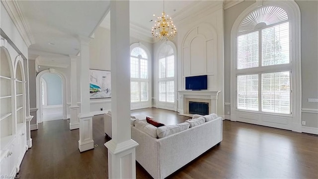 living room featuring a decorative wall, dark wood-type flooring, and crown molding