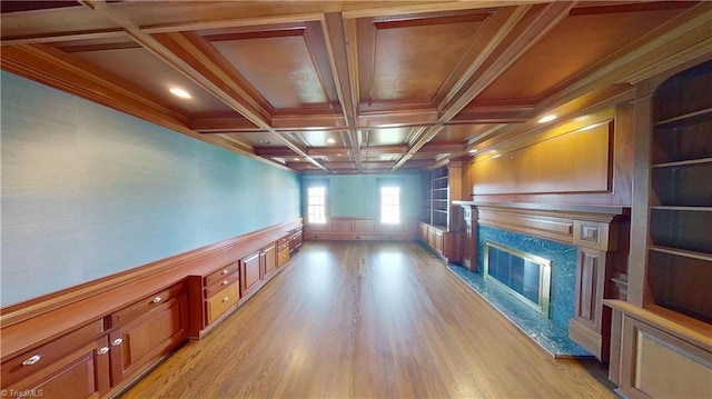 interior space featuring ornamental molding, a high end fireplace, recessed lighting, radiator, and light wood-style flooring
