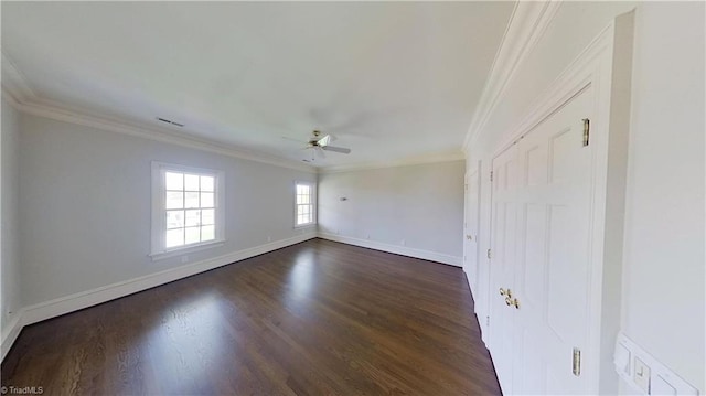 spare room with a ceiling fan, dark wood-type flooring, baseboards, and ornamental molding