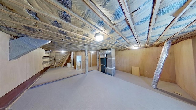 unfinished below grade area with stairway and heating unit