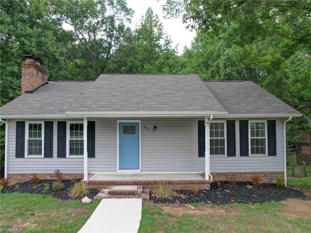 ranch-style home with a chimney and a porch