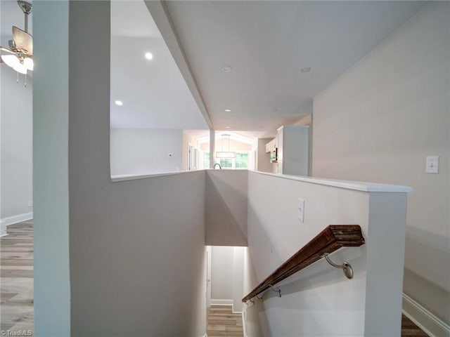 stairs with ceiling fan and hardwood / wood-style floors