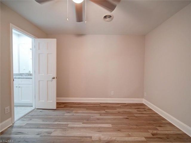 unfurnished room featuring light hardwood / wood-style floors, sink, and ceiling fan