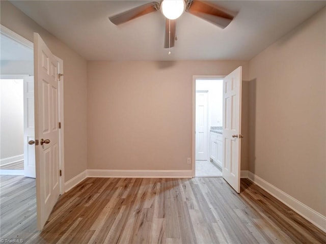 empty room with ceiling fan and light wood-type flooring