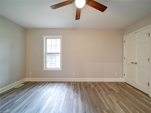 empty room featuring ceiling fan and light hardwood / wood-style floors