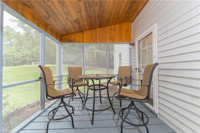 sunroom / solarium featuring vaulted ceiling and plenty of natural light