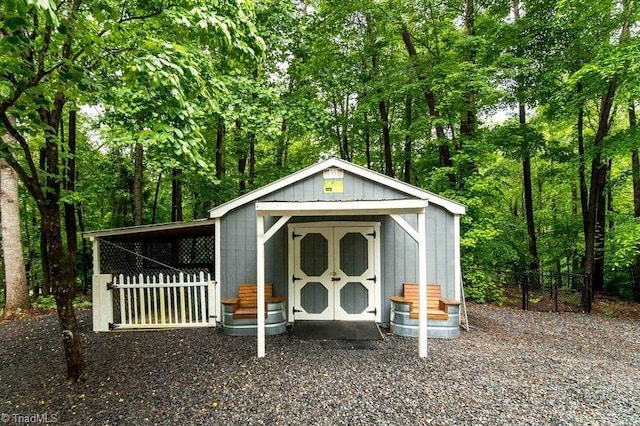 view of shed featuring fence