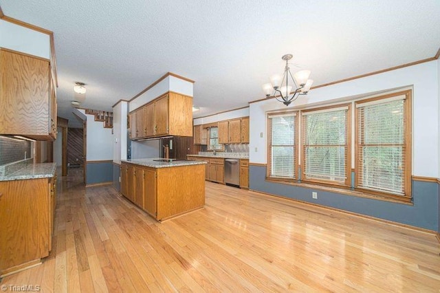 kitchen featuring brown cabinets, stainless steel dishwasher, a chandelier, ornamental molding, and light wood-style flooring