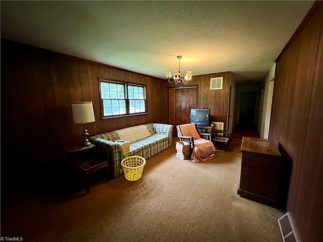5261 Windemere Cir, Trinity, NC 27370 - living room featuring carpet, a chandelier, wooden walls, and a textured ceiling