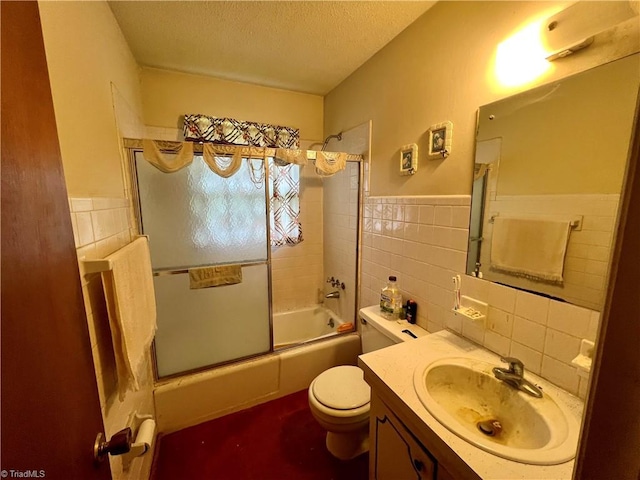 5261 Windemere Cir, Trinity, NC 27370 - full bath featuring tile walls, a textured ceiling, shower / bath combination with glass door, toilet, and vanity