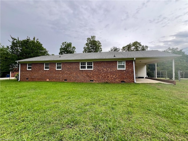 5261 Windemere Cir, Trinity, NC 27370 - rear view of house with crawl space, a carport, a yard, brick siding, and a patio