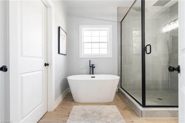 115 Corbin Ln, Lexington, NC 27295 - bathroom featuring a shower stall, a freestanding tub, and wood finished floors