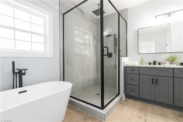 115 Corbin Ln, Lexington, NC 27295 - bathroom with a shower stall, vanity, a freestanding bath, wood finished floors, and healthy amount of natural light