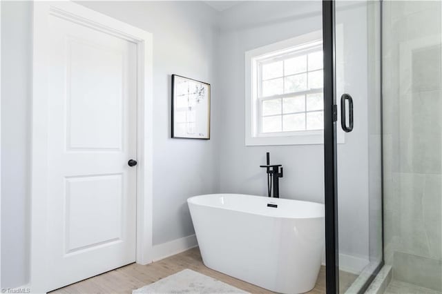 115 Corbin Ln, Lexington, NC 27295 - bathroom featuring a soaking tub, a stall shower, and wood finished floors