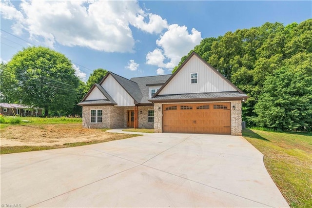 115 Corbin Ln, Lexington, NC 27295 - view of front facade with concrete driveway, a garage, a front yard, brick siding, and board and batten siding