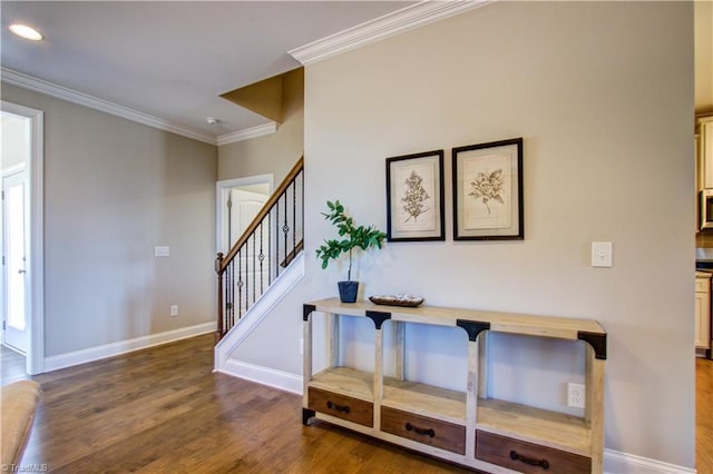 foyer featuring ornamental molding and hardwood / wood-style flooring