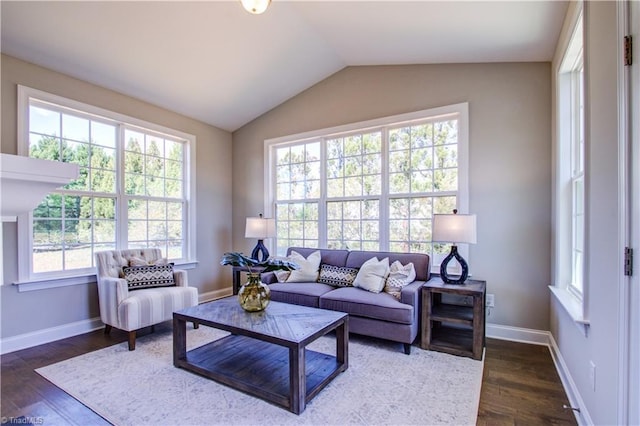 living room with plenty of natural light, dark wood-type flooring, and lofted ceiling