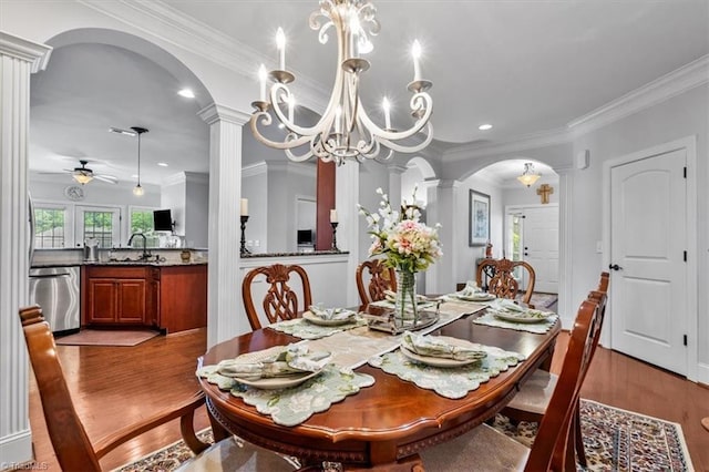 3615 Sainsbury Ln, Greensboro, NC 27409 - dining area with arched walkways, decorative columns, wood finished floors, crown molding, and a ceiling fan