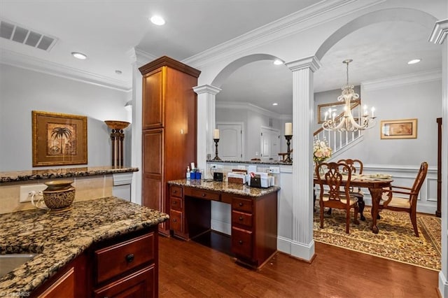 3615 Sainsbury Ln, Greensboro, NC 27409 - kitchen featuring arched walkways, dark wood finished floors, decorative columns, dark stone counters, and recessed lighting
