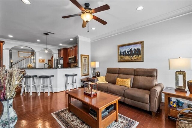 3615 Sainsbury Ln, Greensboro, NC 27409 - living room featuring ornate columns, ceiling fan, arched walkways, crown molding, and hardwood / wood-style flooring