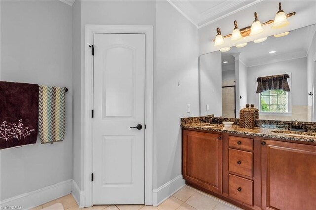 3615 Sainsbury Ln, Greensboro, NC 27409 - bathroom with ornamental molding, baseboards, double vanity, tile patterned floors, and a shower