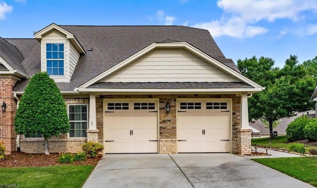 3615 Sainsbury Ln, Greensboro, NC 27409 - craftsman-style home featuring concrete driveway, a garage, a shingled roof, and stone siding