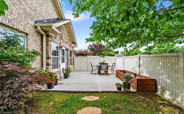 3615 Sainsbury Ln, Greensboro, NC 27409 - fenced backyard featuring a patio area