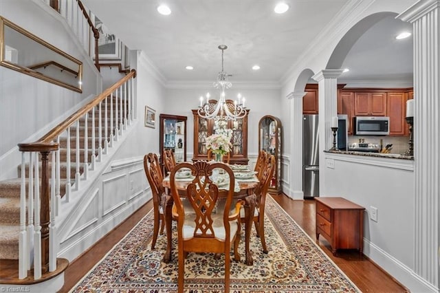 3615 Sainsbury Ln, Greensboro, NC 27409 - dining room with arched walkways, recessed lighting, ornate columns, stairs, and dark wood finished floors