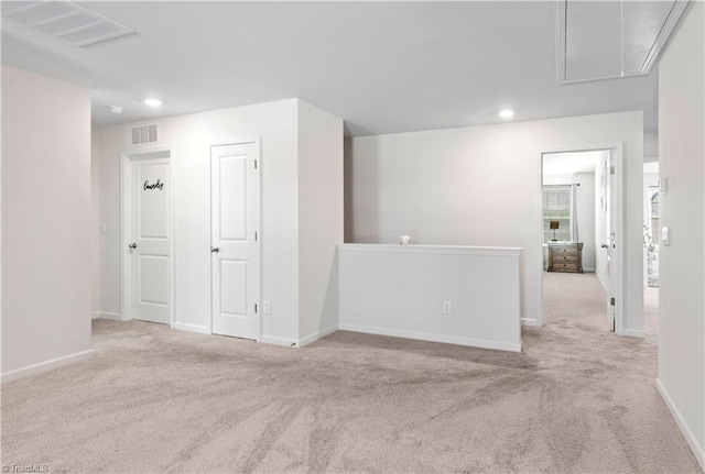 carpeted spare room with recessed lighting, baseboards, visible vents, and attic access