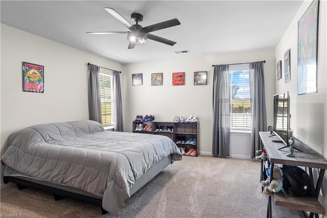 bedroom with baseboards, visible vents, ceiling fan, and carpet