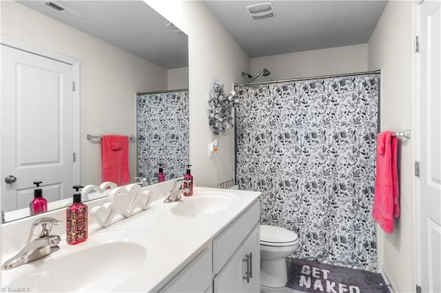 full bathroom featuring toilet, visible vents, and a sink