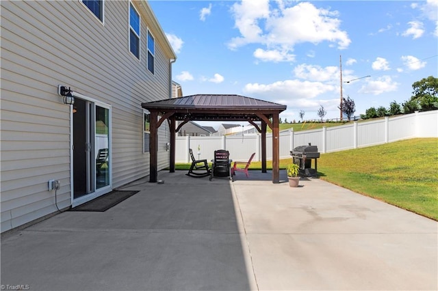 view of patio featuring a gazebo, a fenced backyard, and grilling area