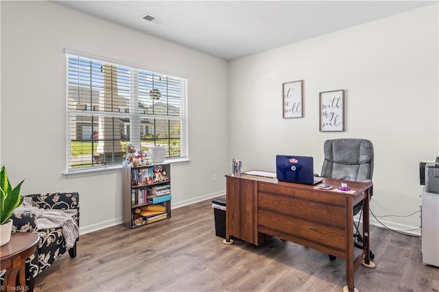 home office with visible vents, baseboards, and wood finished floors